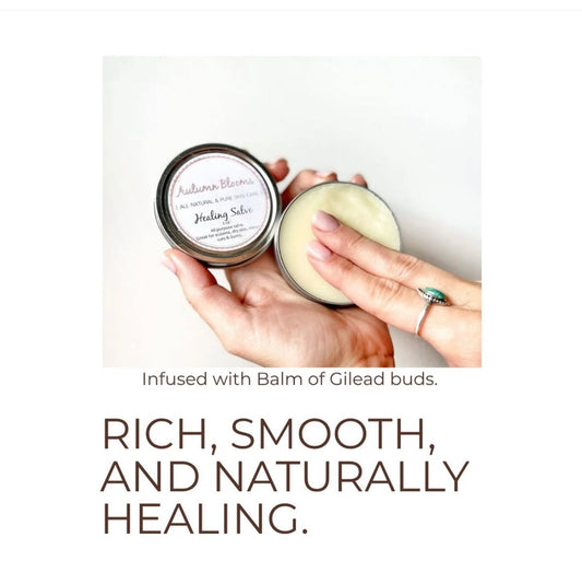 Tin of natural,  moisturizing healing salve for dry, sensitive skin being held by someone. 